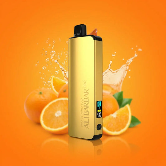 Gold-colored aluminum alibarbar pro vaporizer with black accents and digital display for orange fanta soda use